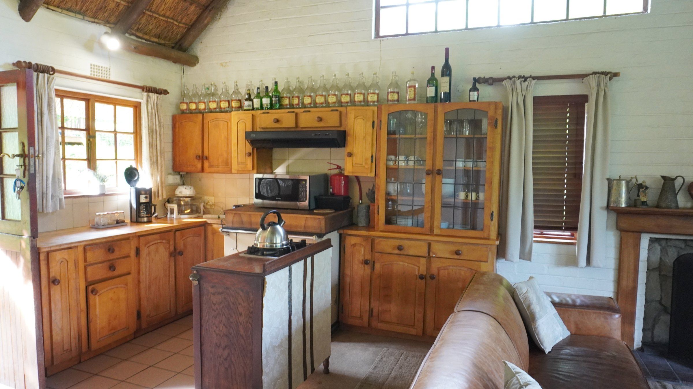 De-vine View's pine kitchen, with a breakfast counter and a glass-fronted dresser