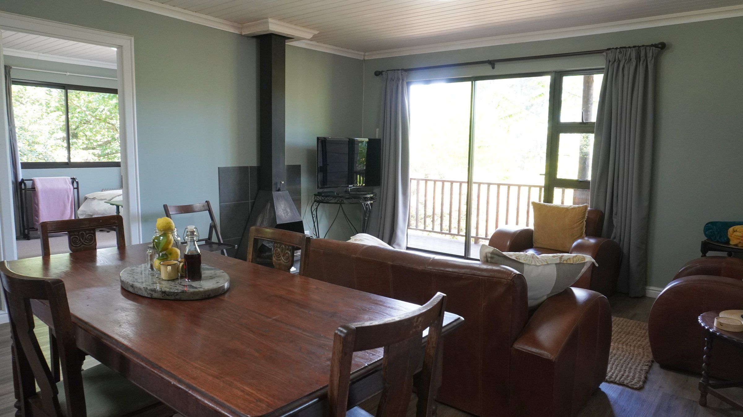 EverGreen Lodge's dining table, with the lounge and wood-burning stove beyond