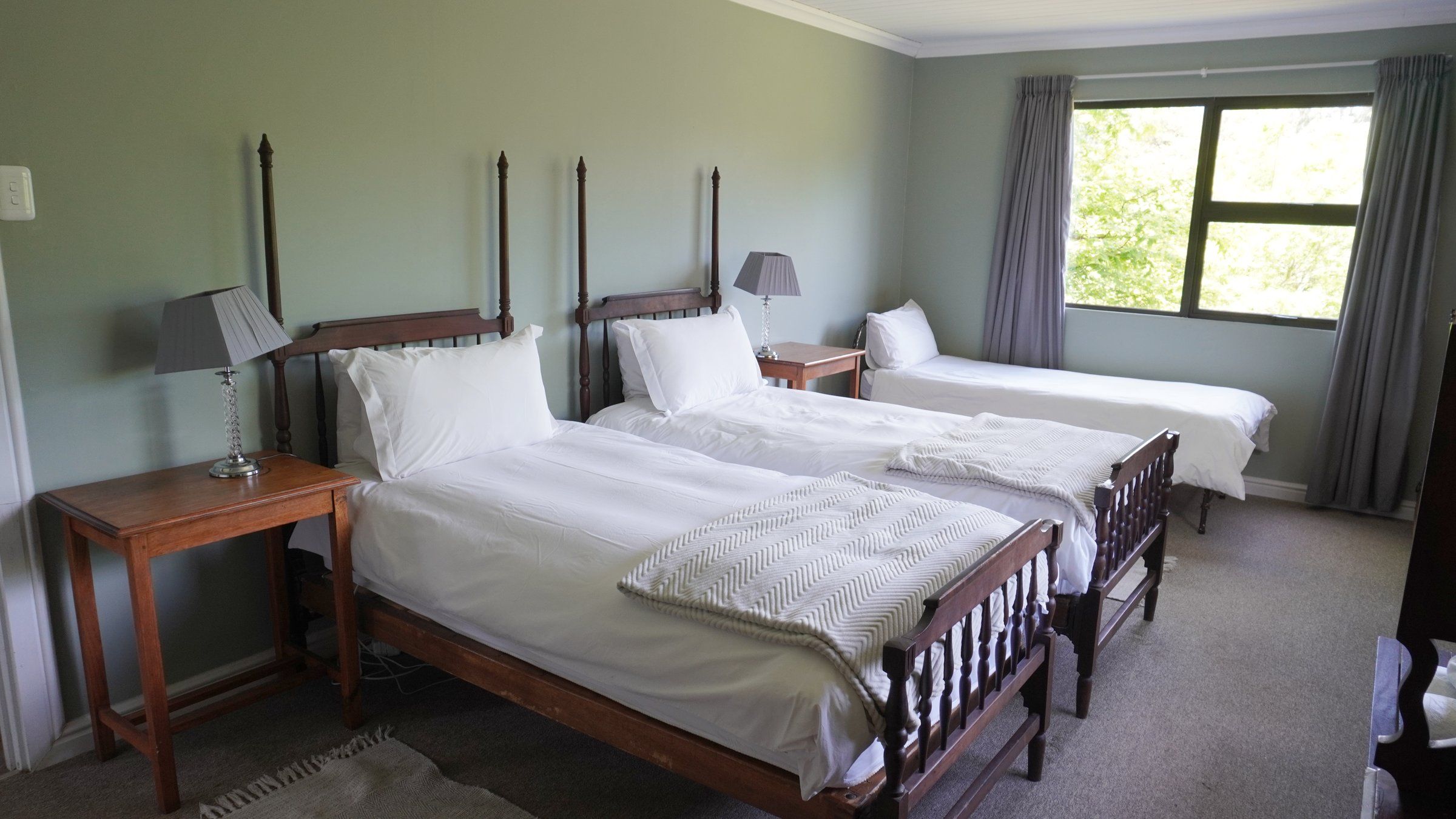 EverGreen Lodge bedroom one made up as twin beds, with the third single by the window